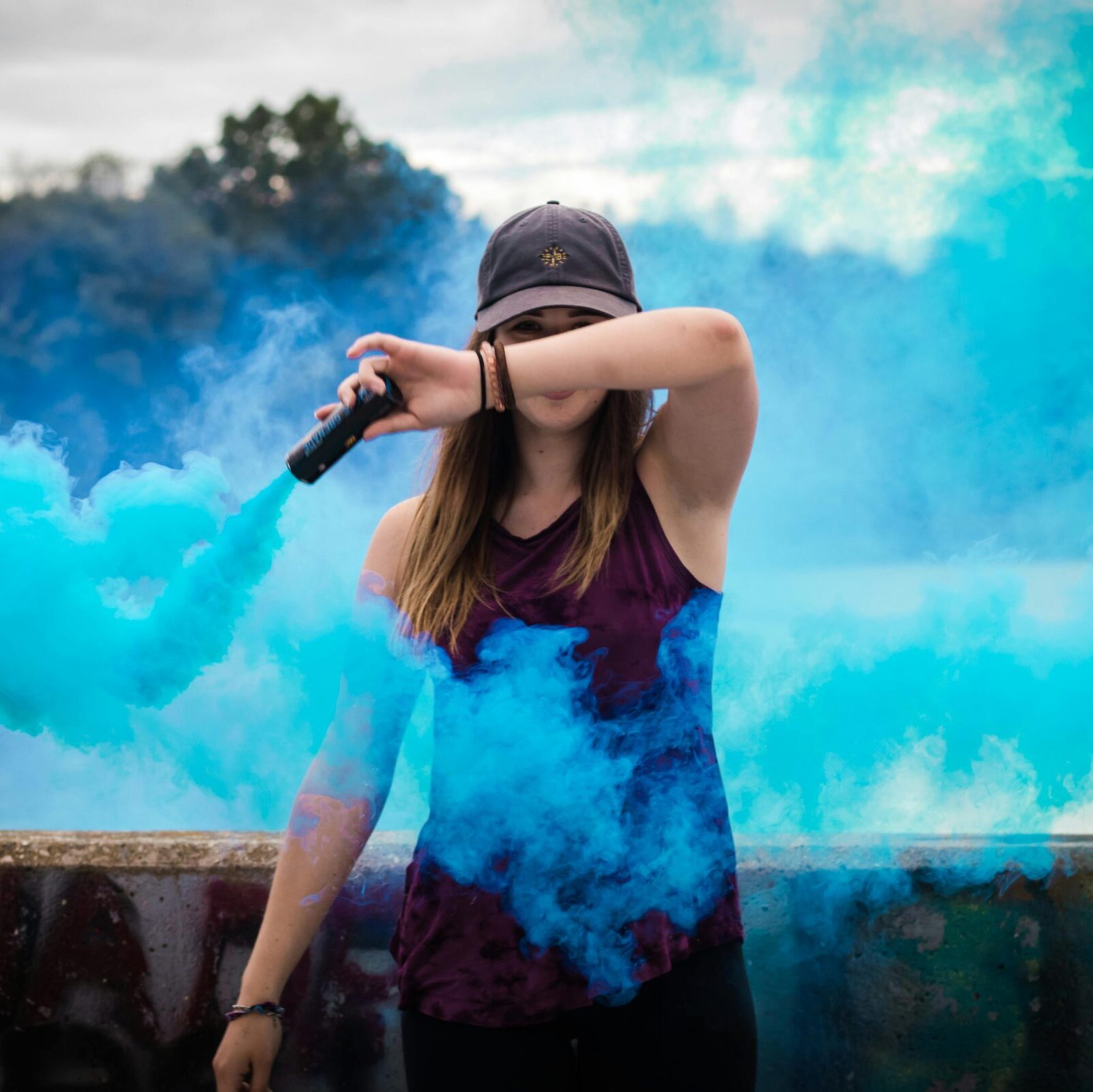 Woman Holding Blue Smoke Flare